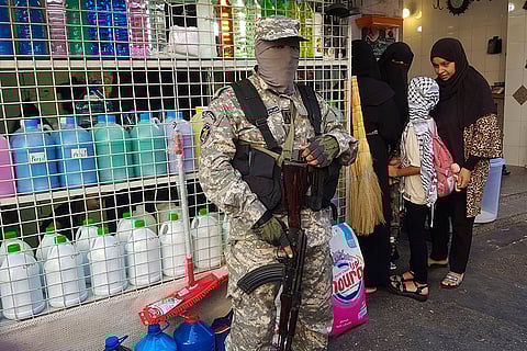 Israeli drone strike in Lebanon: A Palestinian Fatah fighter from Al-Aqsa Martyrs' Brigades stands guard